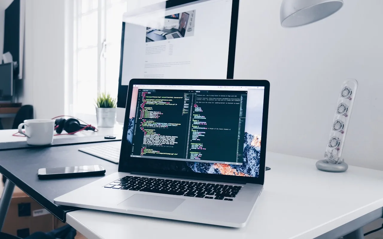 Software developer working on custom application code on a laptop